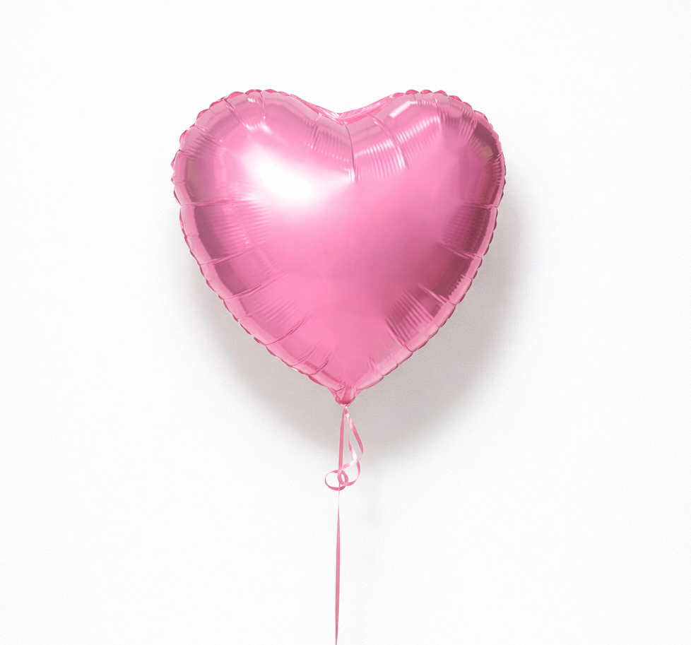 Pink heart-shaped balloon on a white background