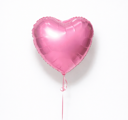 Pink heart-shaped balloon on a white background