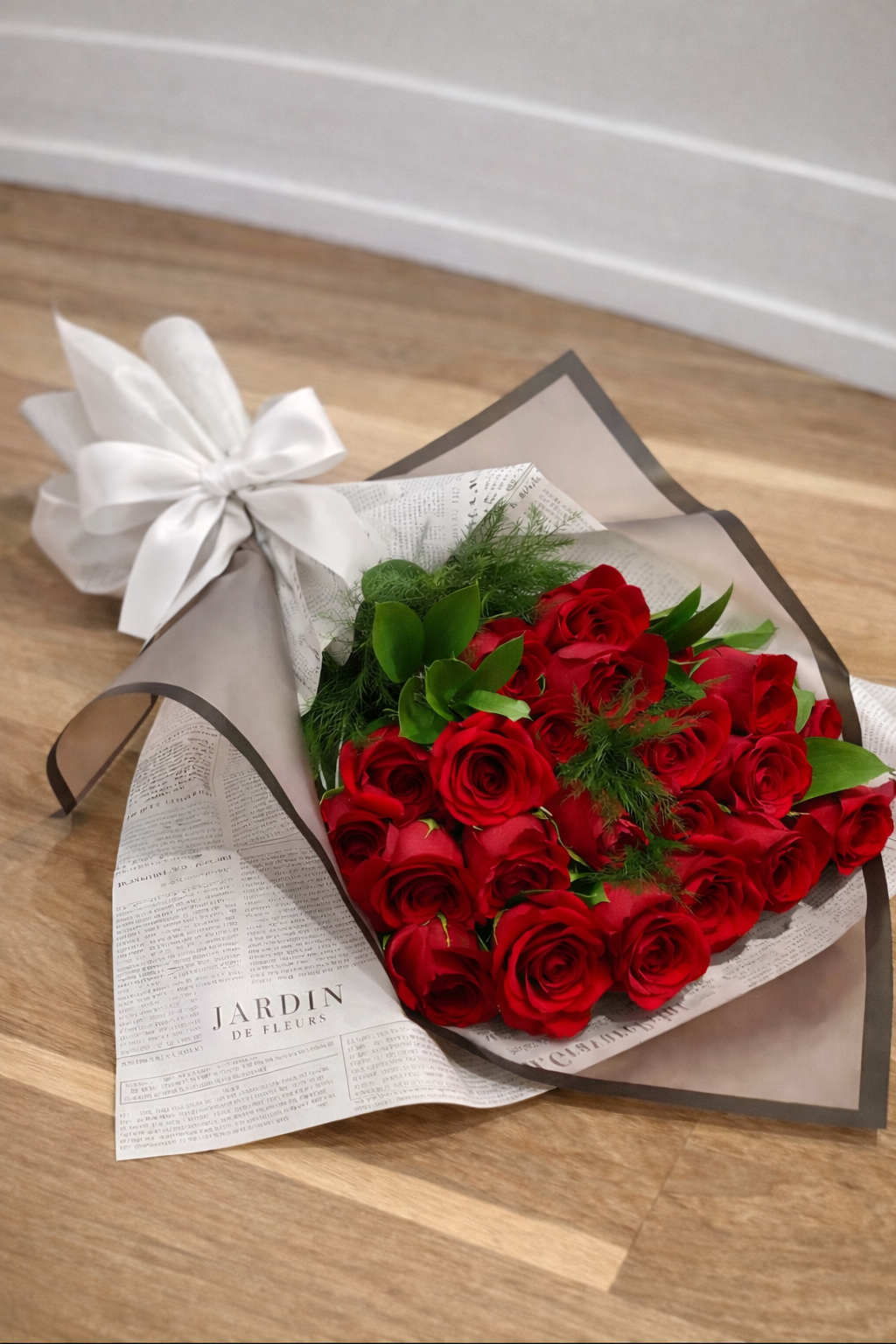 A bouquet of red roses wrapped in paper