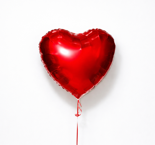 Red heart-shaped balloon on a white background
